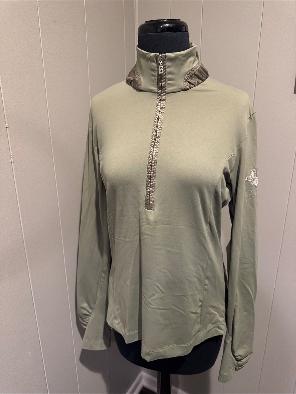 Bogner sage green ruched satiny accent 1/2 zip embroidered crystal logo top. ML